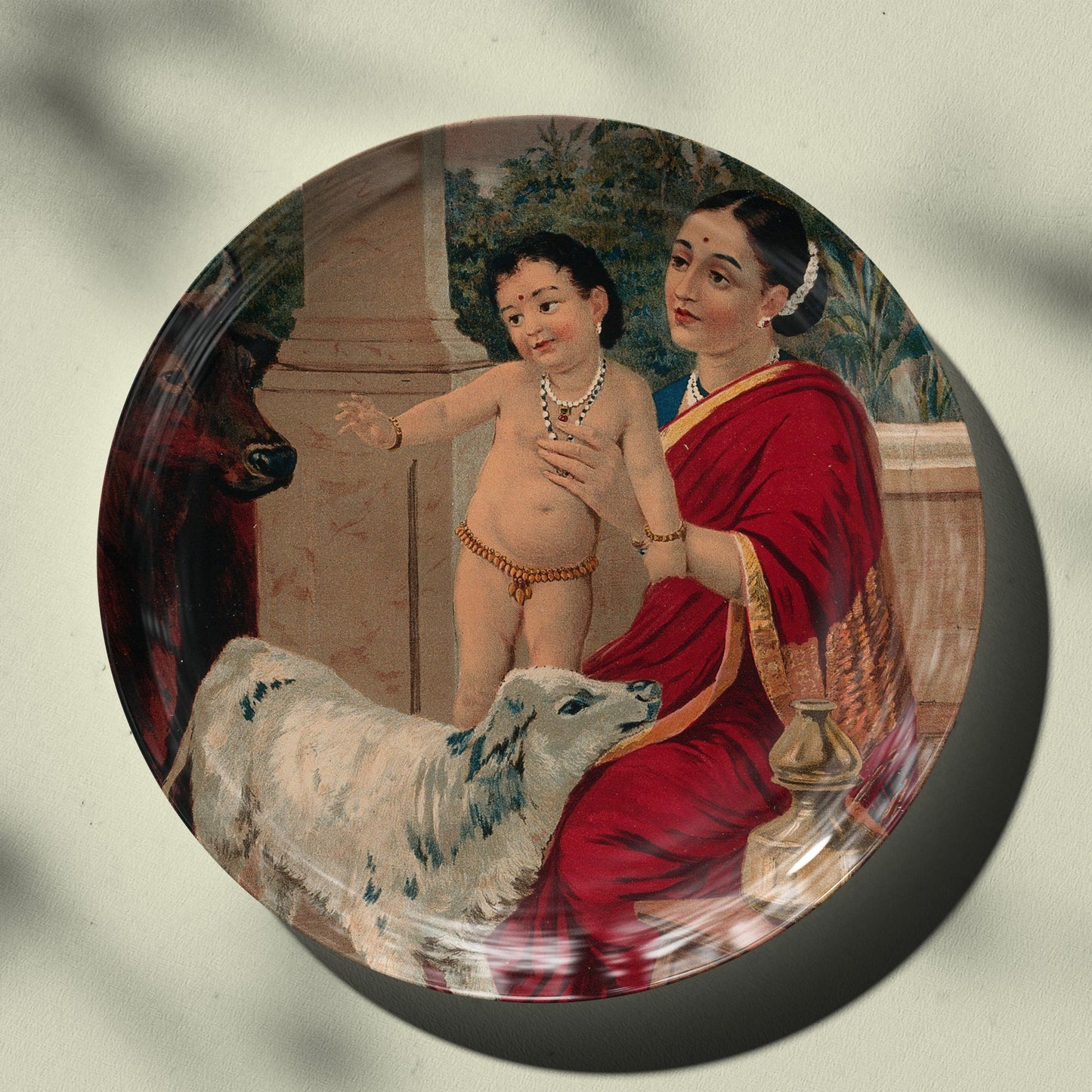 Krishna as an infant on Yasoda's lap playing with a cow and a calf by Ravi Varma Ceramic Plate for Home Decor